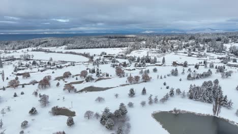 Drone-shot-of-a-large-golf-course-on-Whidbey-Island-covered-in-snow