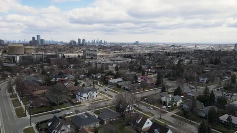 Drone-flying-toward-downtown-suburban-area-near-Toronto-in-winter