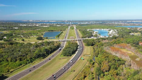Aerial-shot-of-three-lane-highway-and-road-bridge-towards-Sarasota,-Florida