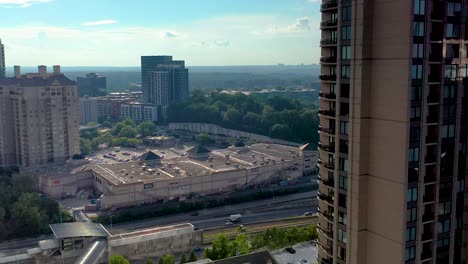 Slowly-rising-drone-shot-of-the-Paramount-skyscraper-with-Buckhead-and-the-surrounding-Atlanta-area-in-the-background