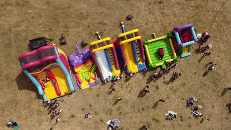 Top-down-aerial-view-of-kids-playing-in-inflatable-playground