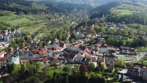 Aerial-reveal-of-a-picturesque-old-European-town-located-among-green-hills