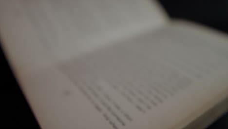 A-close-up-shot-tracking-backwards-across-the-pages-of-an-open-book