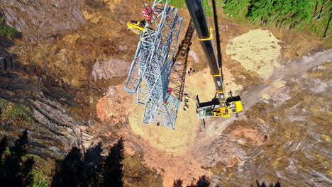 Electrical-Linemen-Working-On-Assembly-Of-Transmission-Tower-With-Mobile-Crane