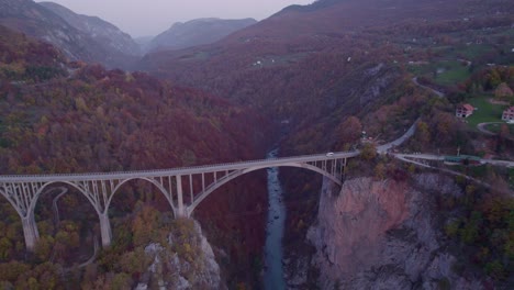 Tara-concrete-arch-bridge-crossing-steep-canyon-in-Montenegro,-aerial