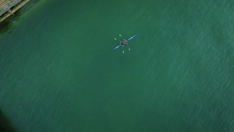 aerial-top-down-of-canoe-kayak-double-couple-seat-rowing-in-stream-green-water-river-training-for-olympics-game