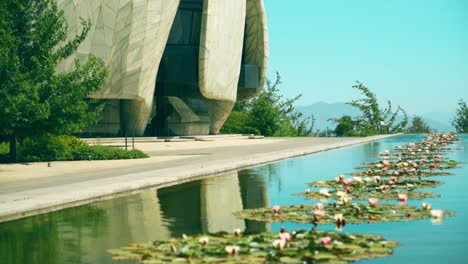 Reflection-of-the-Bahai-Temple-of-South-America-in-the-lagoon-of-lotus-flowers,-temple-of-worship-that-invites-all-religions,-solitary-and-respectful-place
