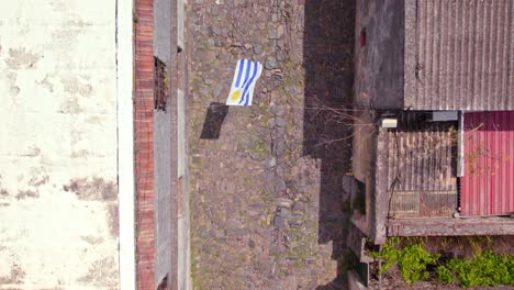 Uruguay-Flag-In-Calle-De-Los-Suspiros-In-Uruguay---Aerial