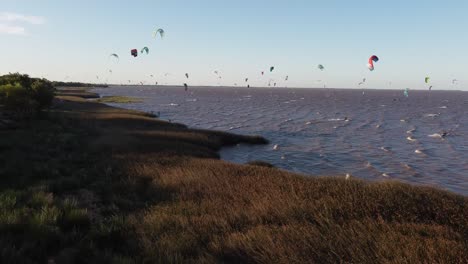 Shot-Of-Kite-Surfers-On-River-At-Sunset,-Vicente-Lopez-Area,-Buenos-Aires,-Rio-de-la-Plata