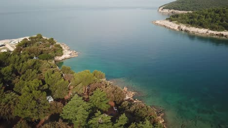 Aerial-view-over-a-rural-campgrounds-on-Croatia's-shoreline
