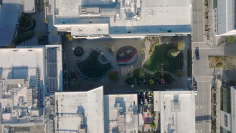 Rising-drone-shot-of-the-outdoor-green-space-and-rooftops-in-the-Hillsdale-Shopping-Center
