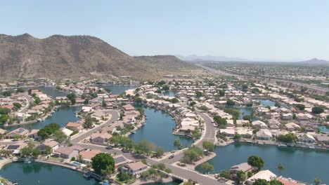 Aerial-view-of-manmade-waterways-leading-between-lavish-retirement-homes-in-Phoenix,-Arizona