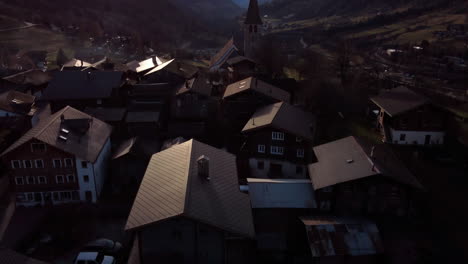 Long-flight-over-the-mountain-valley-and-rural-houses-of-Ernen
