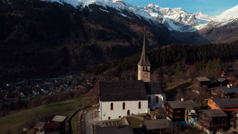 Aerial-view-of-the-old-mountain-church-in-Ernen,-Switzerland