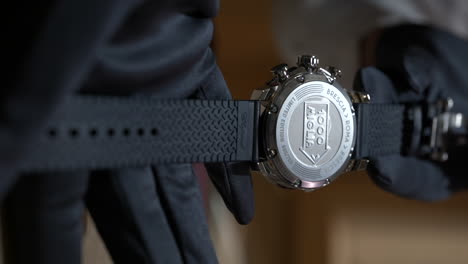 Hands-showing-expensive-luxury-chopard-1000-miglia-brand-watch,-rear-side,-macro