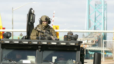 Attentive-fully-equipped-soldier-on-top-of-the-truck,-during-Freedom-Convoy-protests