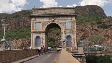 Visitors-walk-and-drive-through-stone-arch-over-Hartbeespoort-Dam