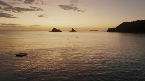 Tourists-Stand-Up-Paddle-Boarding-At-Sunset-In-Costa-Rica-Beach-Near-Guanacaste-In-Central-America