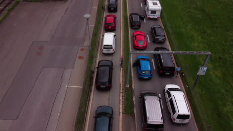 Aerial-view-of-cars-lining-up-to-enter-a-railway
