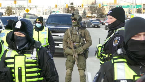 Police-officers-closely-watching-Freedom-convoy-in-Windsor,-Ontario,-Canada