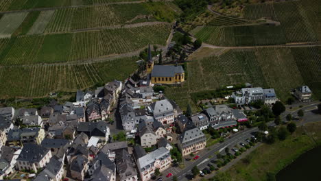Backward-flight-from-a-church-in-the-middle-of-a-village-and-a-vineyard