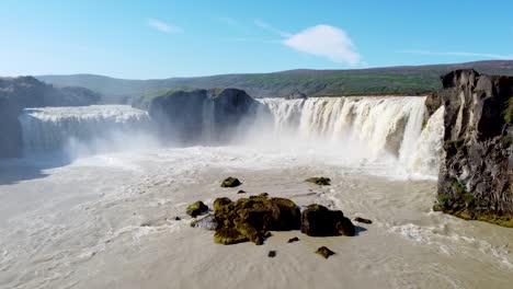 Majestic-wide-waterfall-of-Godafoss-in-Iceland,-low-altitude-aerial-view