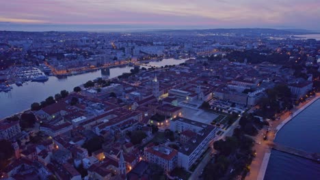 Zadar-city-in-Croatia-before-sunrise-with-city-lights-still-on,-aerial