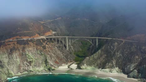 Bixby-Canyon-Bridge-on-Foggy-Big-Sur-California-Day,-Aerial-Drone-Flight