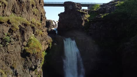 Waterfall-in-Kolugljufur-Canyon,-Iceland.-Aerial-pedetal-up