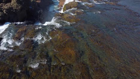 Sparkling-fresh-water-flowing-down-the-Kolufossar-waterfall-in-Iceland-springtime,-drone-view