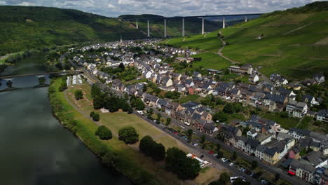 Flight-over-a-village-next-to-Moselle-and-vineyard