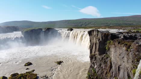 Godafoss-Waterfall-with-rising-mist-in-Iceland,-aerial-drone-view