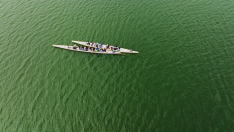 A-rotating-drone-shot-over-two-boats-over-a-large-Asian-river-on-a-cloudy-day