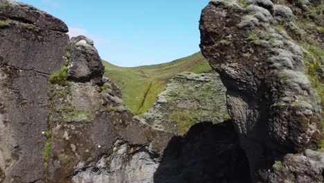 Huge-Cliffs-in-Fjaðrárgljúfur-Canyon,-Iceland-in-aerial-dolly-in-between-rocks