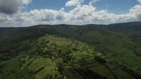 Mountain-Top-Villages,-drone-view-of-green-plains,-carbon-footprint-and-climate-crisis,-nature-landscape,-forestry-and-agriculture