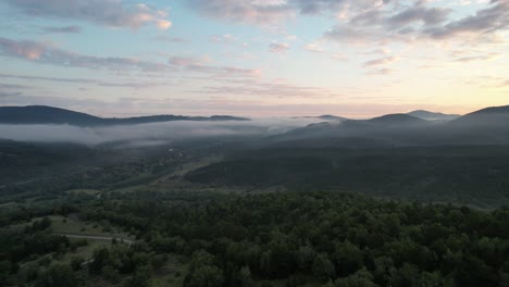 Evening-Forestainous,-mountain-areas-foggy-clouds,-drone-view-of-coniferous-pine-forest,-footage-from-green-nature,-agriculture-and-forestry