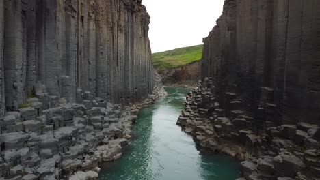 Narrow-and-deep-river-valley-of-stone-in-Iceland,-aerial-view