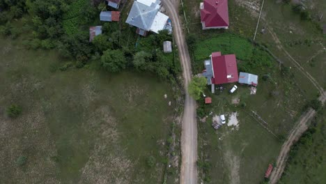 Aerial-Farmhouses,-drone-view-of-brown-herd-cows,-agriculture-and-livestock-in-the-highland,-mountain-village-houses,-turkish-springs-drone-view