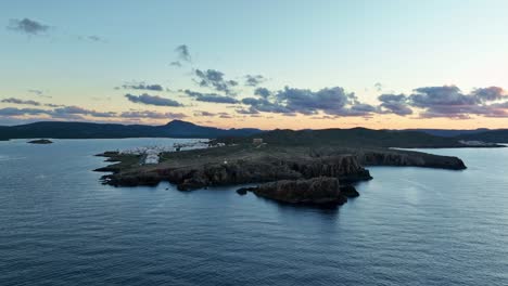 Cinematic-drone-flyover-Defence-tower-in-Menorca,-Spain-at-sunset
