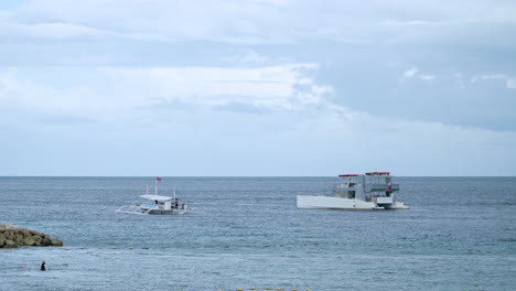 Outrigger-Boat-Next-To-A-Tourist-Yacht-On-Cruise-At-The-Beach-Of-Mactan-In-Cebu,-Philippines