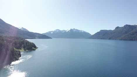 AERIAL---Sunny-reflection-on-Traful-lake,-Patagonia,-Río-Negro,-Argentina,-truck-right