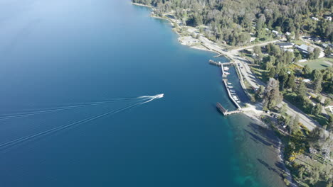 AERIAL---Boat-approaching-pier-at-Traful-Lake,-Patagonia,-Río-Negro,-Argentina,-forward