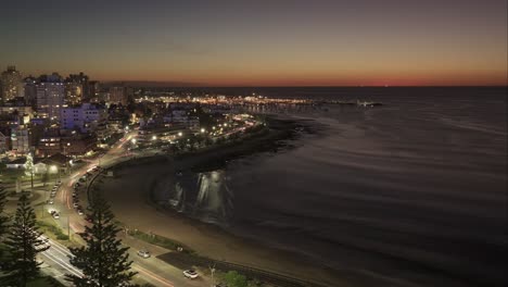 Aerial-timelapse-shot-of-traffic-on-coastal-road-in-Punta-del-Este-City-at-sunset-time