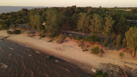 Aerial-Shot-Of-People-Playing-Beach-Volley-On-Fray-Bentos-Coast,-Uruguay