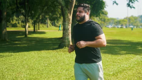 Man-focused-jogging-outdoors-on-a-sunny-day-in-slowmotion