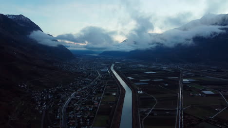 Aerial-flight-over-river-Rhone-flowing-through-the-city-Martigny-in-the-Alps