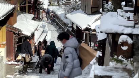 Shop-Owners-Removing-Ice-From-Stairs,-Higashiyama-and-Gion,-Kyoto,-Japan