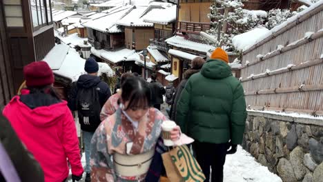 Asian-Women-in-Kimono-Walking-up-Stairs-During-Winter,-Higashiyama-and-Gion,-Kyoto,-Japan