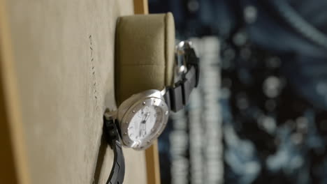 VERTICAL-Slow-motion-panning-across-expensive-Panerai-contemporary-maritime-wristwatch-close-up-shallow-focus