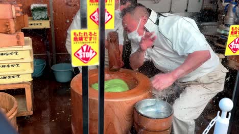 Mochi-pounding-Proess-by-Japanese-Male-at-Worlds-Most-Famous-Mochi-Place,-Nara,-Japan